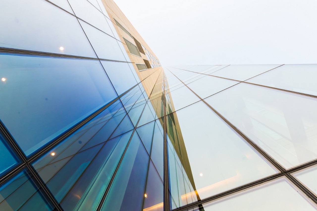Glass modern building against bright sky