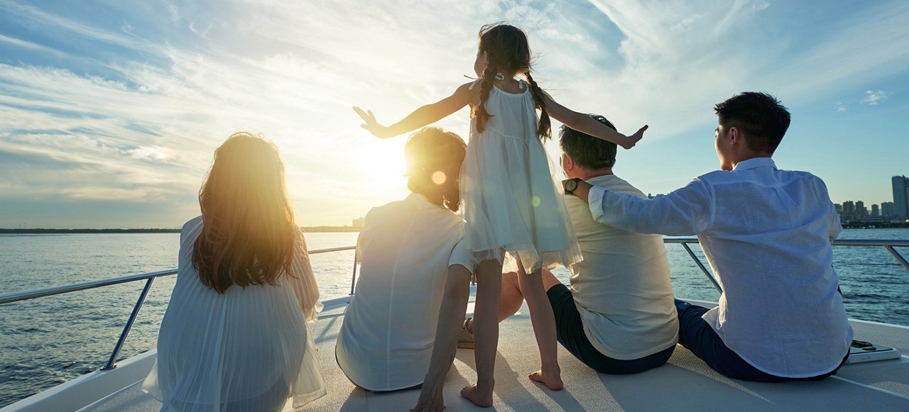Happy family aboard a yacht out to sea
