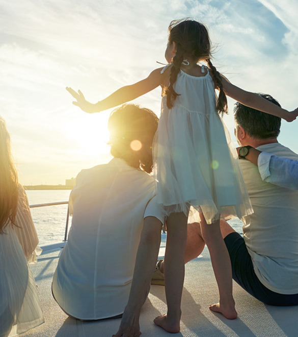 Happy family aboard a yacht out to sea