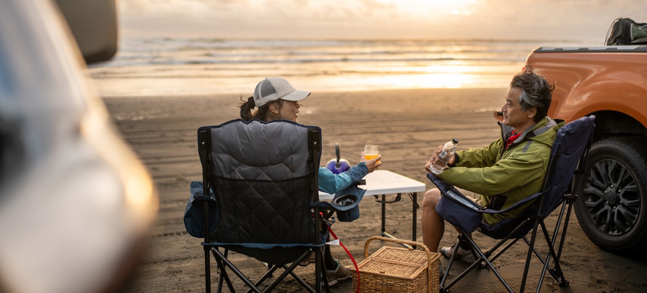A mature couple having a picnic on the beach